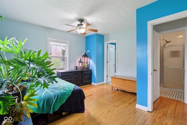 5945 Mcfarland Rd, Indianapolis, IN 46227 - bedroom featuring a textured ceiling, baseboards, light wood finished floors, and a ceiling fan