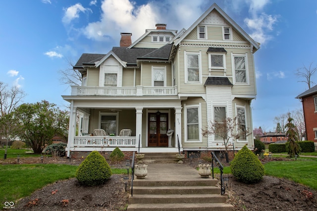 313 E Wabash Ave, Crawfordsville, IN 47933 - victorian home featuring roof with shingles, a porch, a balcony, and a chimney