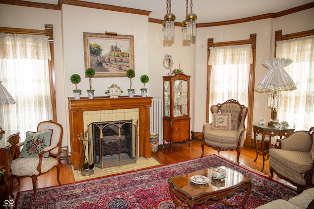 313 E Wabash Ave, Crawfordsville, IN 47933 - sitting room with a tile fireplace, baseboards, crown molding, and wood finished floors