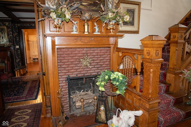 313 E Wabash Ave, Crawfordsville, IN 47933 - living room with a wainscoted wall, stairway, wood finished floors, and a fireplace
