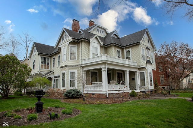313 E Wabash Ave, Crawfordsville, IN 47933 - view of front of property featuring a front yard, a porch, and a chimney
