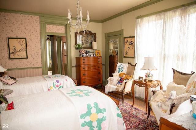 313 E Wabash Ave, Crawfordsville, IN 47933 - bedroom with a notable chandelier, wallpapered walls, crown molding, a wainscoted wall, and wood finished floors