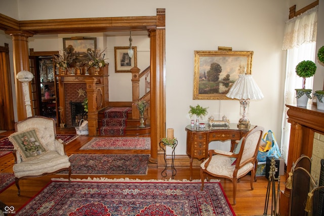 313 E Wabash Ave, Crawfordsville, IN 47933 - living area featuring stairs, wood finished floors, and a fireplace