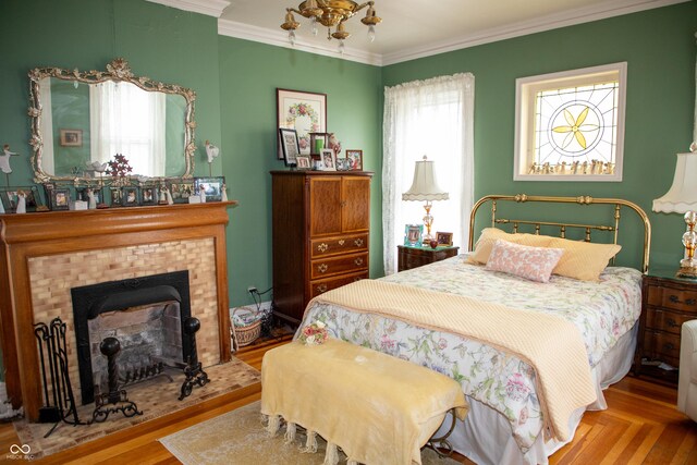 313 E Wabash Ave, Crawfordsville, IN 47933 - bedroom featuring a tiled fireplace, ornamental molding, and multiple windows