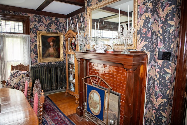 313 E Wabash Ave, Crawfordsville, IN 47933 - interior space featuring wallpapered walls, radiator heating unit, beamed ceiling, and wood finished floors