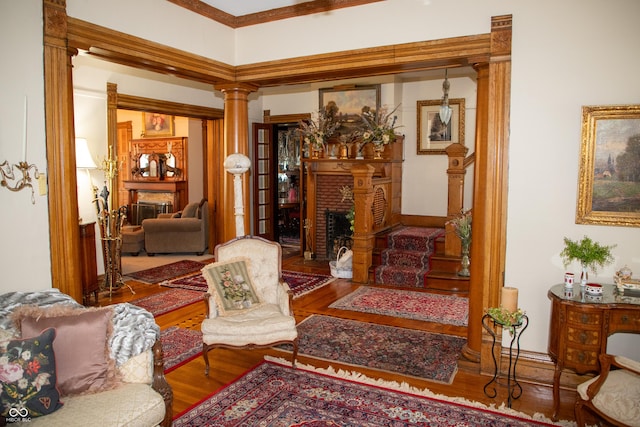 313 E Wabash Ave, Crawfordsville, IN 47933 - sitting room featuring a fireplace, ornate columns, and wood finished floors