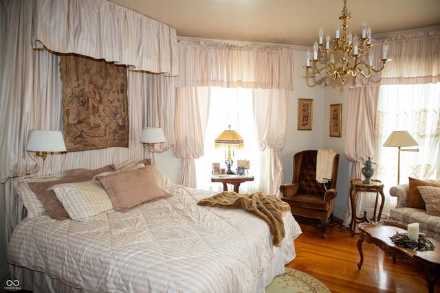 313 E Wabash Ave, Crawfordsville, IN 47933 - bedroom featuring a notable chandelier and wood finished floors