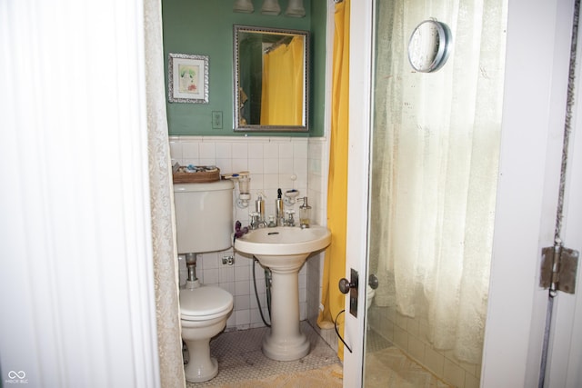 313 E Wabash Ave, Crawfordsville, IN 47933 - bathroom with toilet, tile walls, a walk in shower, wainscoting, and tile patterned floors