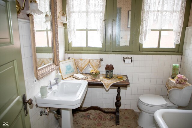 313 E Wabash Ave, Crawfordsville, IN 47933 - bathroom featuring toilet, a sink, tile patterned flooring, and tile walls