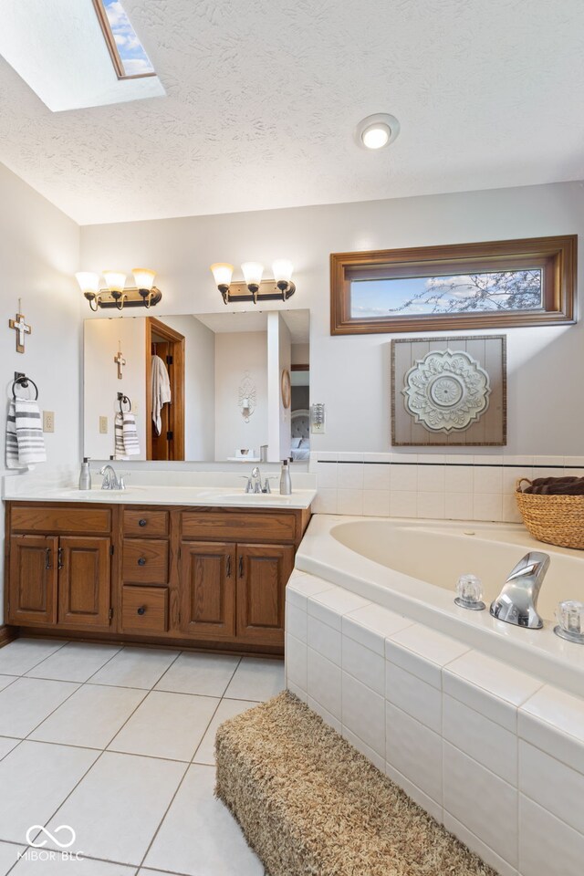 8095 Christopher Ct, Avon, IN 46123 - full bathroom with a bath, tile patterned floors, a sink, double vanity, and a skylight