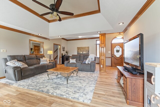 8095 Christopher Ct, Avon, IN 46123 - living area with light wood finished floors, a raised ceiling, ceiling fan, stairway, and ornamental molding