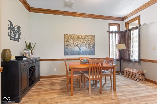8095 Christopher Ct, Avon, IN 46123 - dining area with baseboards, ornamental molding, light wood-style floors, and visible vents