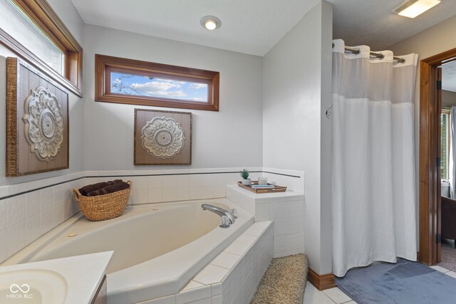 8095 Christopher Ct, Avon, IN 46123 - full bathroom featuring a bath, plenty of natural light, a shower with curtain, and tile patterned flooring