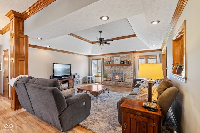 8095 Christopher Ct, Avon, IN 46123 - living area featuring ceiling fan, crown molding, light wood-style floors, and a raised ceiling