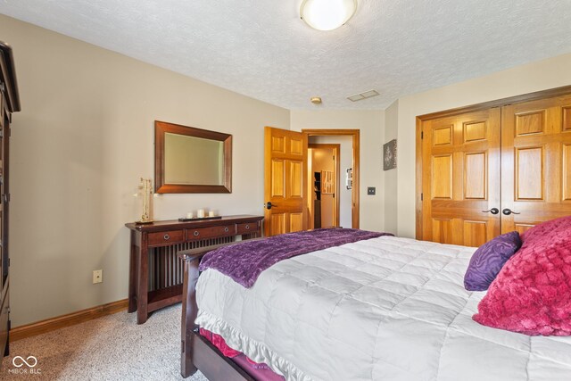 8095 Christopher Ct, Avon, IN 46123 - bedroom with light carpet, baseboards, a textured ceiling, and a closet