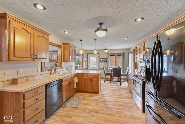8095 Christopher Ct, Avon, IN 46123 - kitchen with a peninsula, light wood-style flooring, a sink, stainless steel electric range oven, and black dishwasher