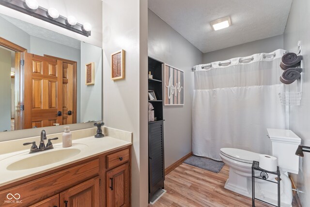 8095 Christopher Ct, Avon, IN 46123 - full bath with wood finished floors, vanity, a shower with curtain, baseboards, and toilet