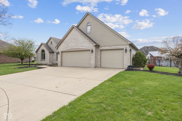 8095 Christopher Ct, Avon, IN 46123 - view of front of home with a garage, driveway, a front yard, and brick siding