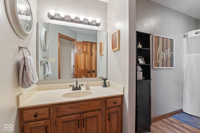 8095 Christopher Ct, Avon, IN 46123 - bathroom with baseboards, wood finished floors, and vanity