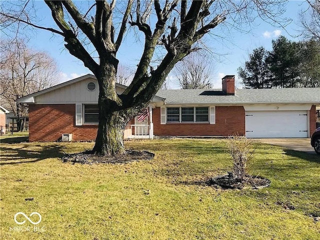 ranch-style home with an attached garage, a chimney, a front yard, and brick siding