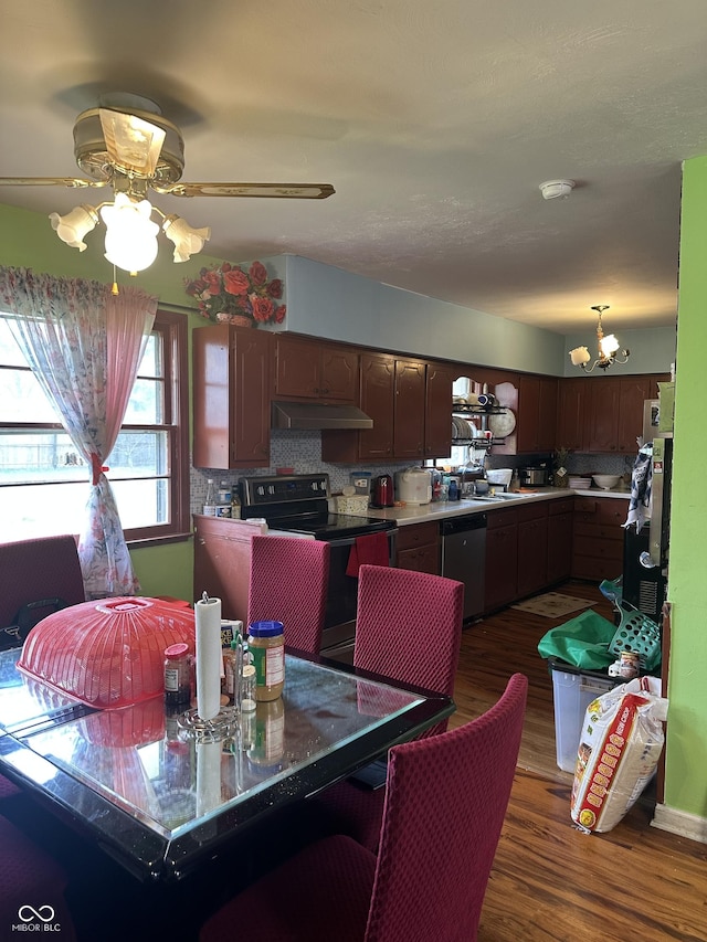 dining area with dark wood-style flooring and ceiling fan with notable chandelier
