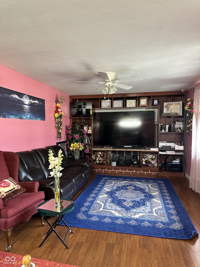 living area with wood finished floors and ceiling fan
