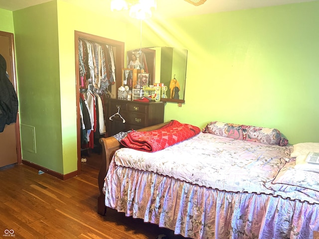 bedroom with wood finished floors and baseboards