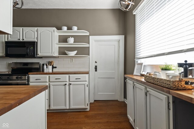 3970 Broadway St, Indianapolis, IN 46205 - kitchen featuring tasteful backsplash, black microwave, butcher block counters, stainless steel range with electric cooktop, and dark wood finished floors