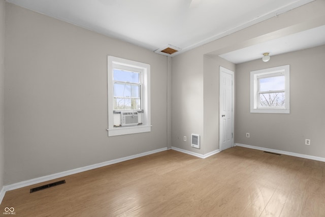 5713 Bluff Rd, Indianapolis, IN 46217 - empty room featuring visible vents, light wood-type flooring, baseboards, and heating unit