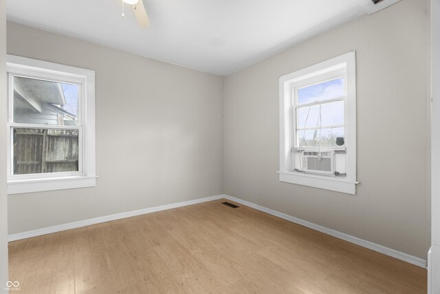 5713 Bluff Rd, Indianapolis, IN 46217 - spare room with visible vents, light wood-style flooring, cooling unit, and baseboards