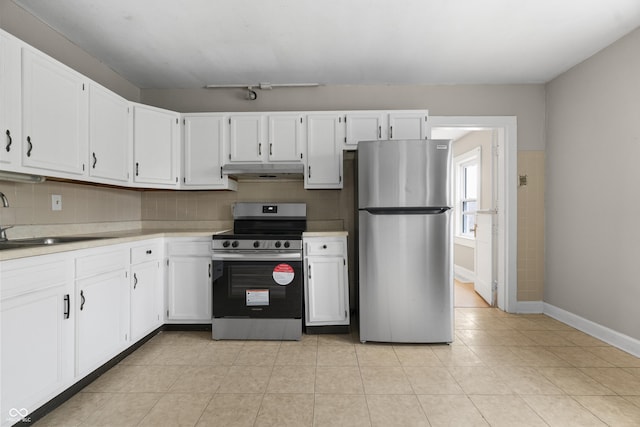 5713 Bluff Rd, Indianapolis, IN 46217 - kitchen featuring stainless steel appliances, under cabinet range hood, a sink, and decorative backsplash