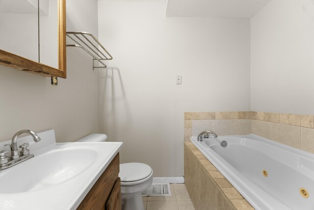 5713 Bluff Rd, Indianapolis, IN 46217 - full bathroom featuring vanity, visible vents, toilet, tile patterned floors, and a jetted tub