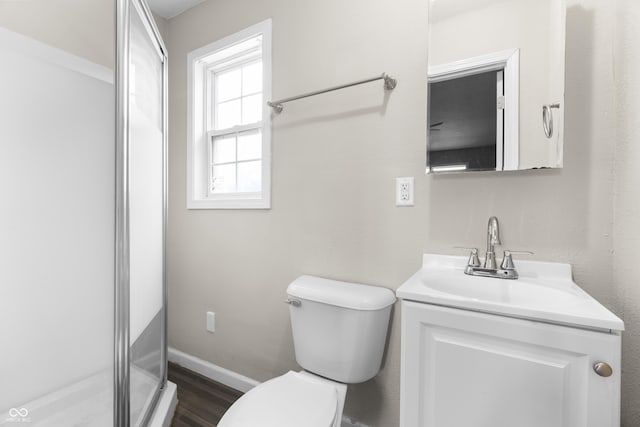 5713 Bluff Rd, Indianapolis, IN 46217 - bathroom featuring baseboards, toilet, a shower, vanity, and wood finished floors