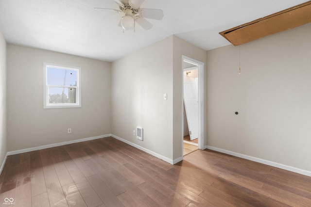 5713 Bluff Rd, Indianapolis, IN 46217 - empty room featuring ceiling fan, visible vents, wood finished floors, attic access, and baseboards