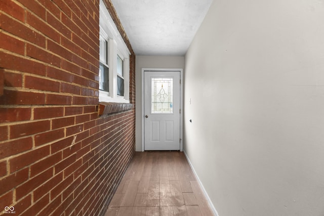 5713 Bluff Rd, Indianapolis, IN 46217 - doorway to outside with baseboards and wood finished floors