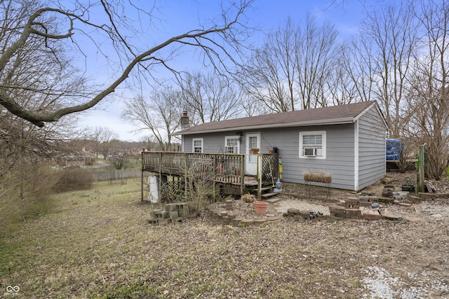 5713 Bluff Rd, Indianapolis, IN 46217 - back of house featuring cooling unit, a chimney, and a wooden deck