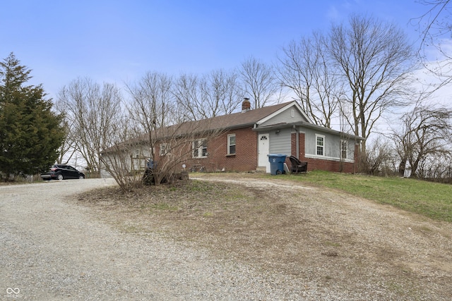 5713 Bluff Rd, Indianapolis, IN 46217 - view of front of property featuring brick siding, driveway, and a chimney