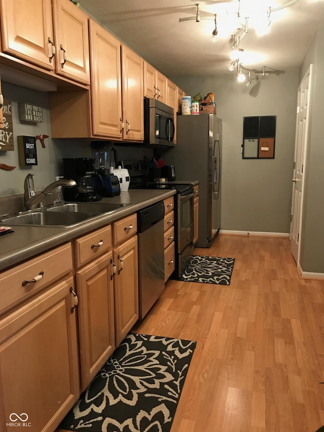 6525 Emerald Hill Ct Unit 208, Indianapolis, IN 46237 - kitchen with light wood-style floors, appliances with stainless steel finishes, baseboards, and a sink