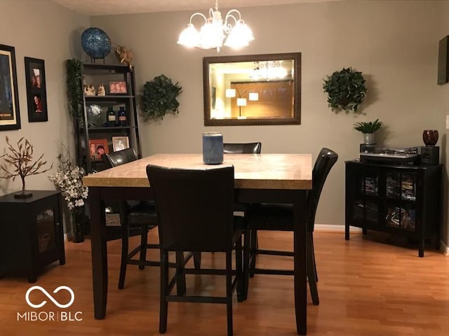 6525 Emerald Hill Ct Unit 208, Indianapolis, IN 46237 - dining space featuring a notable chandelier, baseboards, and light wood-style floors
