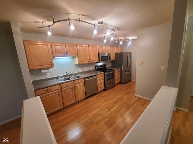 6525 Emerald Hill Ct Unit 208, Indianapolis, IN 46237 - kitchen featuring light wood-style floors, dark countertops, appliances with stainless steel finishes, and a sink