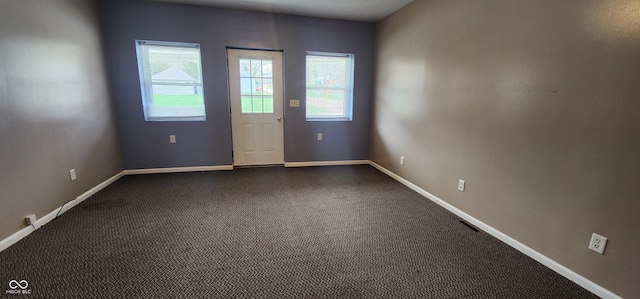 403 S Mill St, Veedersburg, IN 47987 - empty room featuring a wealth of natural light, visible vents, and baseboards