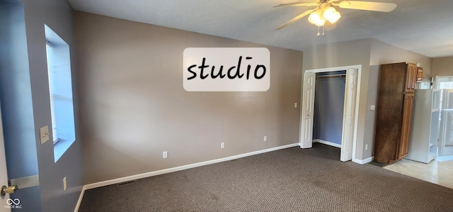 403 S Mill St, Veedersburg, IN 47987 - unfurnished bedroom with a closet, baseboards, visible vents, a ceiling fan, and carpet floors
