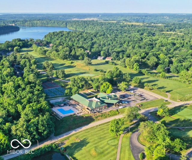 bird's eye view featuring a wooded view and a water view