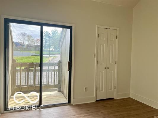 entryway featuring baseboards and wood finished floors