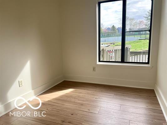 empty room featuring baseboards and wood finished floors