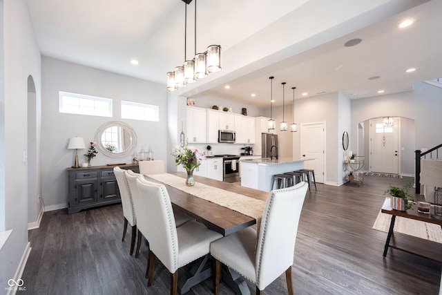 1534 Cloverdon Dr, Westfield, IN 46074 - dining area with arched walkways, baseboards, dark wood-style flooring, and recessed lighting