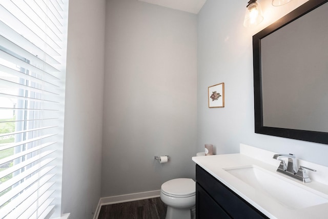 1534 Cloverdon Dr, Westfield, IN 46074 - half bathroom featuring vanity, toilet, wood finished floors, and baseboards