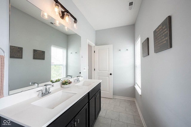 1534 Cloverdon Dr, Westfield, IN 46074 - full bathroom with double vanity, tile patterned floors, and baseboards