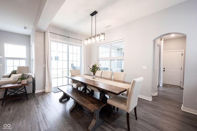 1534 Cloverdon Dr, Westfield, IN 46074 - dining area featuring arched walkways, dark wood-style floors, healthy amount of natural light, and baseboards