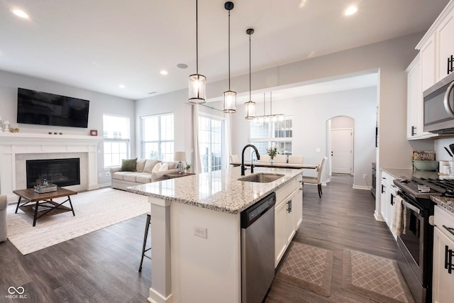 1534 Cloverdon Dr, Westfield, IN 46074 - kitchen with appliances with stainless steel finishes, a sink, recessed lighting, a center island with sink, and dark wood-style floors